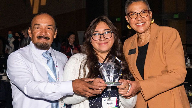 2021 Dottie Lamm Leadership Award winner Natalie Guerra of Denver poses with her award with her dad and WFCO President & CEO, Lauren Y. Casteel
