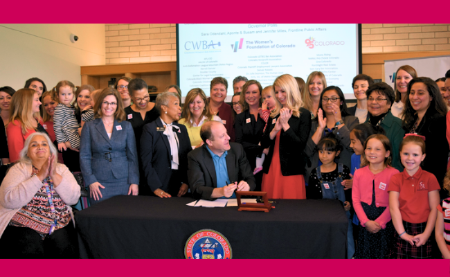 Governor Polis signs the Equal Pay for Equal Work Act at WFCO offices