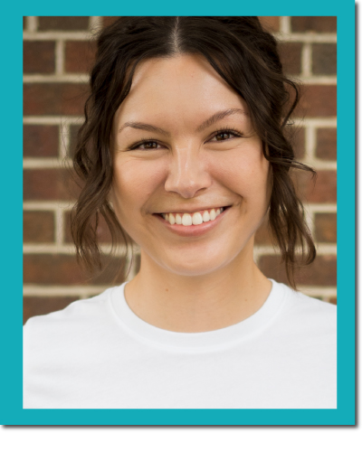 headshot of Mykaela Aguilar: Latina woman with brown hair, smiling and wearing a white shirt