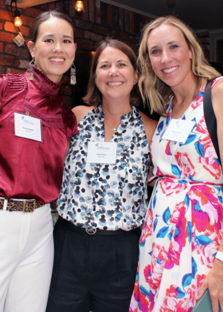 Three women PEP members stand together and smile for camera 