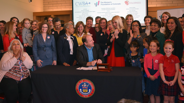 Governor Jared Polis signs Equal Pay for Equal Work Act at WFCO offices