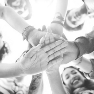 Group of people putting their hands together