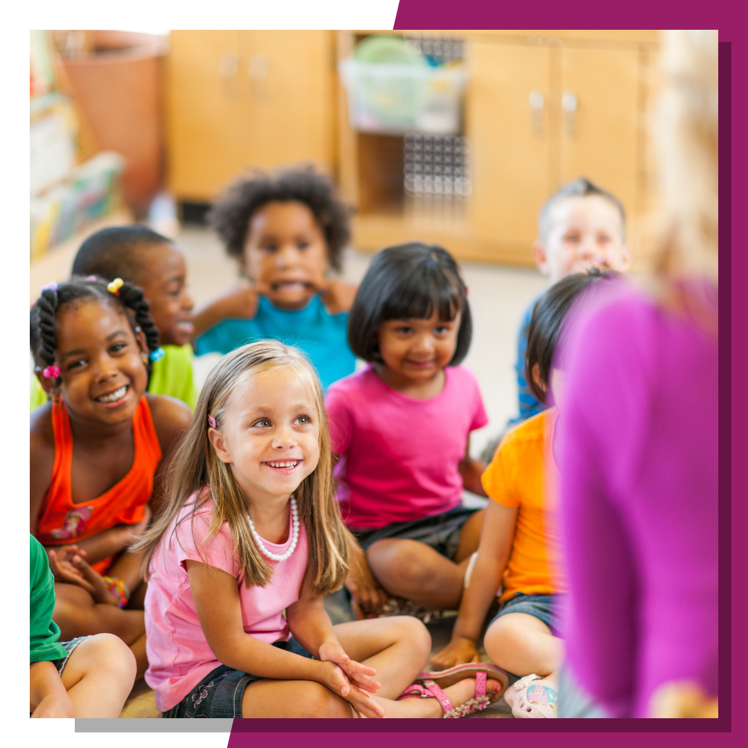 a group of preschool children sit in front of their teacher while smiling